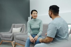 A healthcare professional speaking with a patient in a calm, modern clinic setting, illustrating personalised care and patient marketing across the healthcare journey.