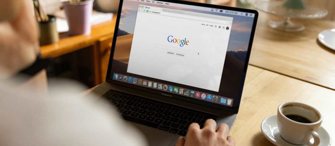 Close-up of a MacBook showing Google search, representing the transition from SEO-first strategies to demand generation content.