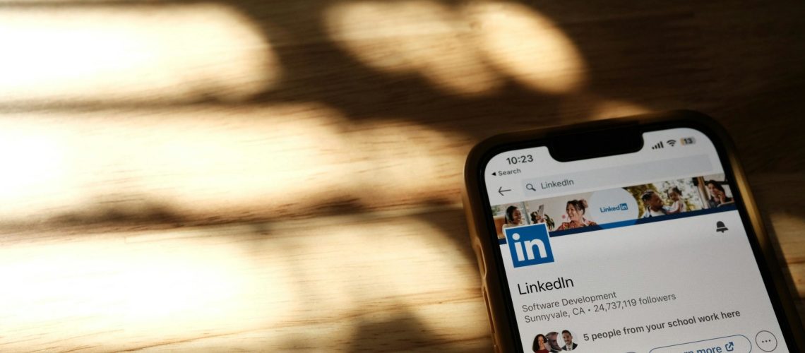 LinkedIn app open on a phone in warm light, supporting linkedin growth efforts.