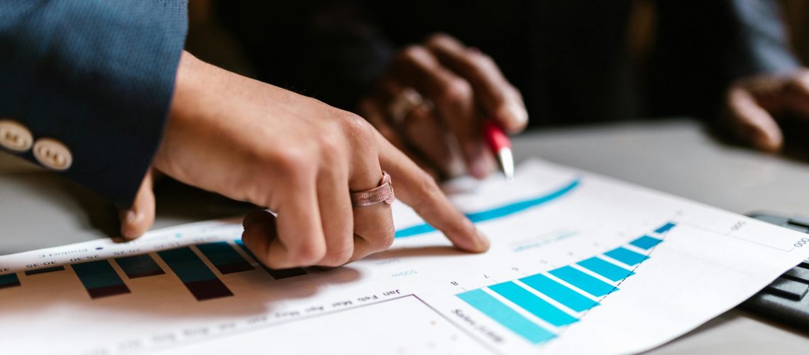 Business professionals analysing a sales growth chart during a B2B marketing strategy meeting.